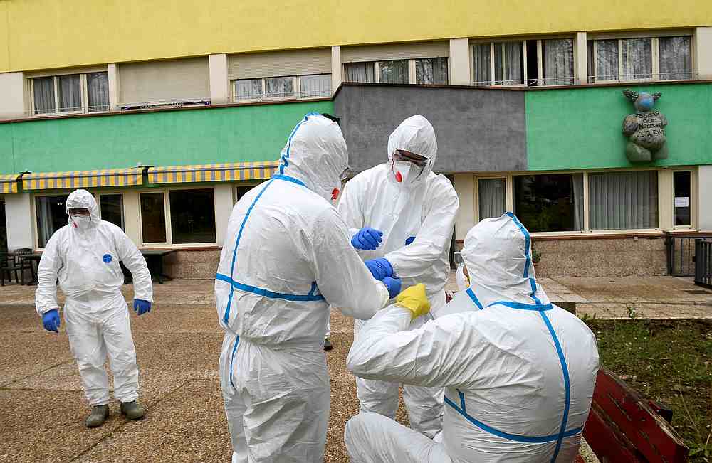 Sanitary workers prepare to clean the nursing home where a woman died and several residents and care providers have been diagnosed with Covid-19 in Grado, Asturias, Spain March 20, 2020. u00e2u20acu201d Reuters pic 