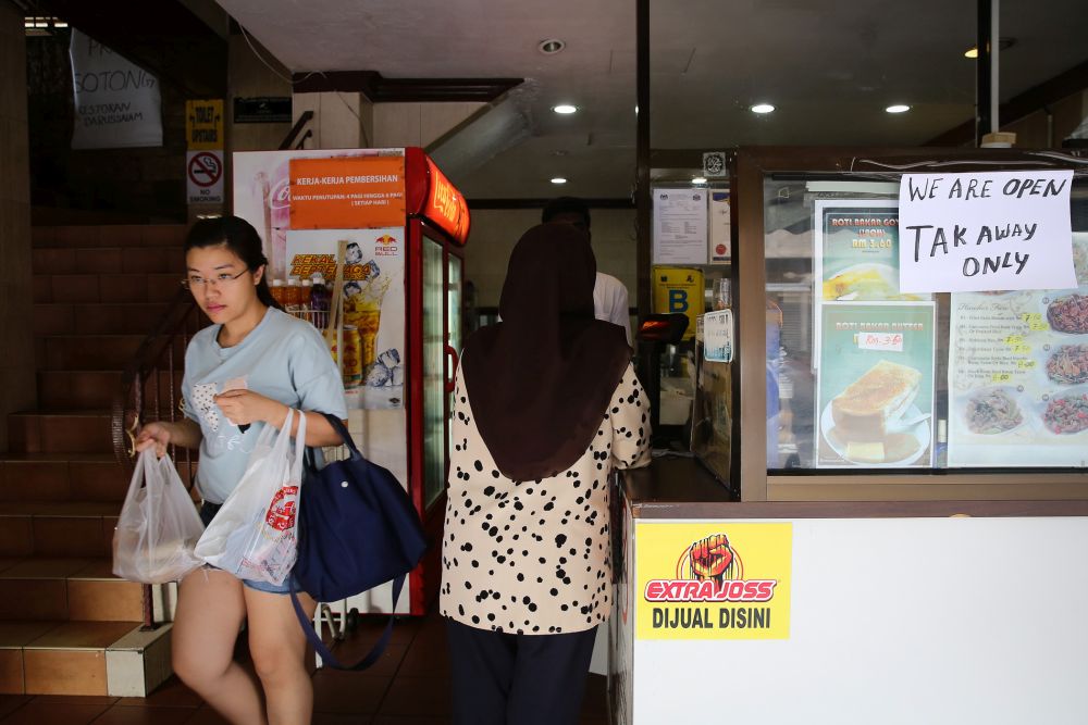 A notice detailing the dine-in restriction is pictured at a restaurant in Subang Jaya as the movement control order kicks in on March 18, 2020. u00e2u20acu201d Picture by Yusof Mat Isa