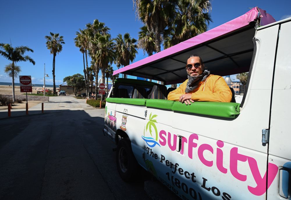 Adam Duford, owner of Surf City Tours, poses for a picture in one of his tour buses on an empty street near the beach in Santa Monica March 23, 2020. u00e2u20acu201d AFP pic