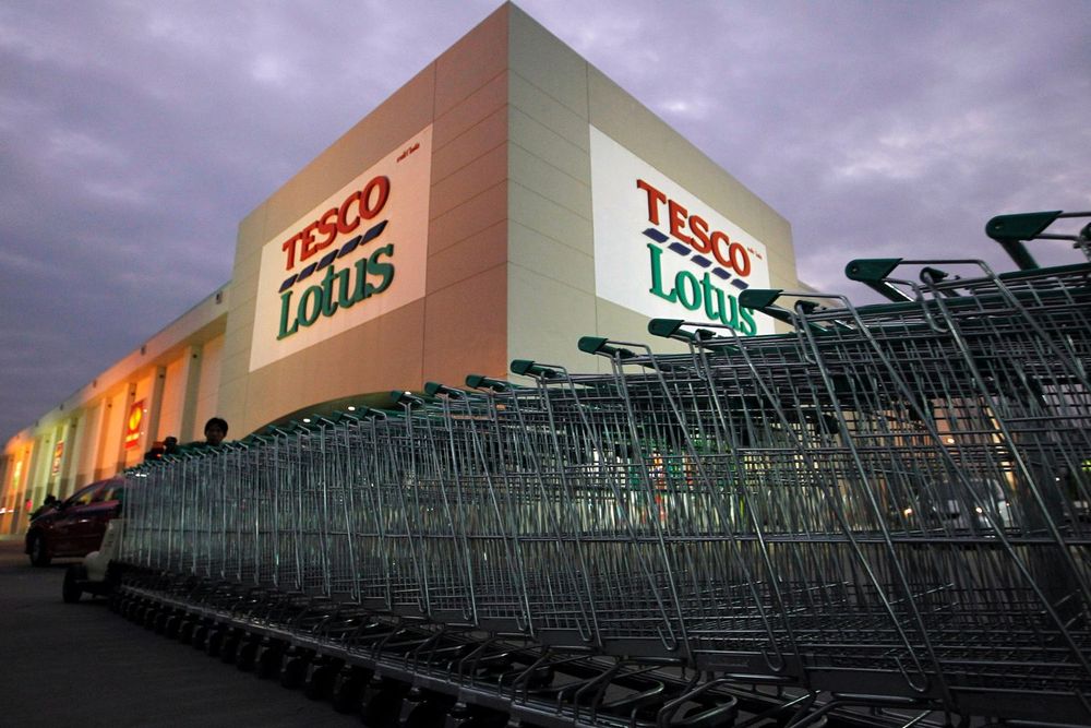 A worker pushes trolleys at a Tesco Lotus supermarket in Bangkok January 12, 2012. u00e2u20acu201d Reuters pic