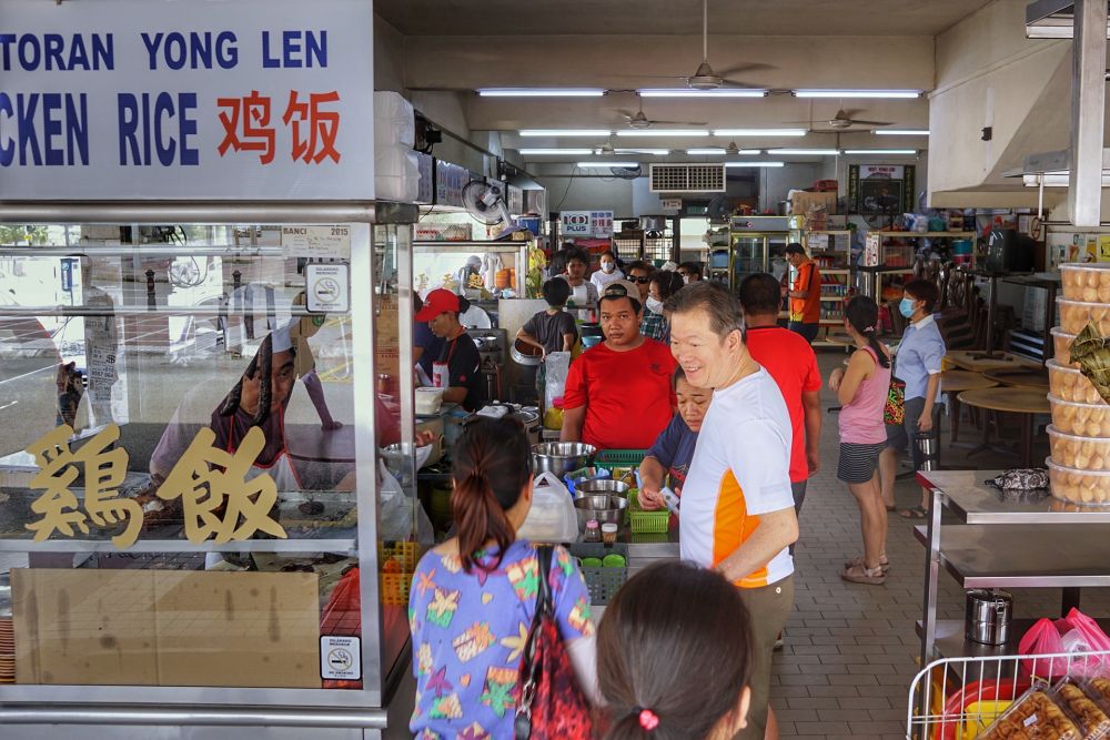 People queue to buy food during lunch hour at a food court in Taman Tun Dr Ismail March 18, 2020. u00e2u20acu201d Picture by Ahmad Zamzahuri