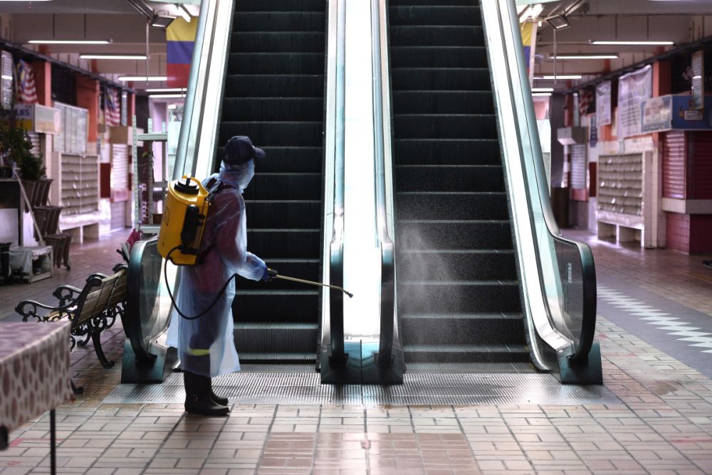 A DBKL worker sprays disinfectant at the Taman Tun Wet Market to prevent the spread of Covid-19 in Petaling Jaya March 25, 2020. u00e2u20acu201d Picture by Miera Zulyana