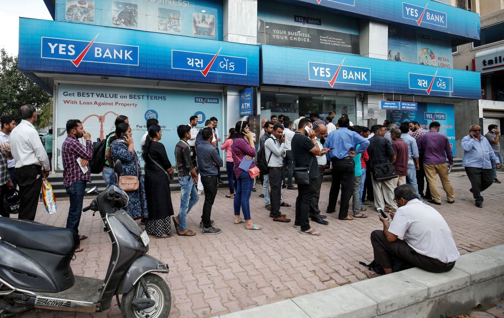 People wait outside a Yes Bank branch to withdraw their money in Ahmedabad, India, March 6, 2020. u00e2u20acu2022 Reuters pic