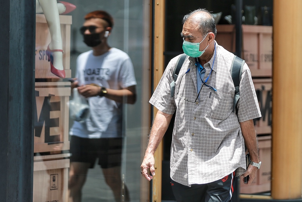Members of the public are seen going about wearing face masks in Kuala Lumpur, March 14, 2020. u00e2u20acu201d Picture by Ahmad Zamzahuri