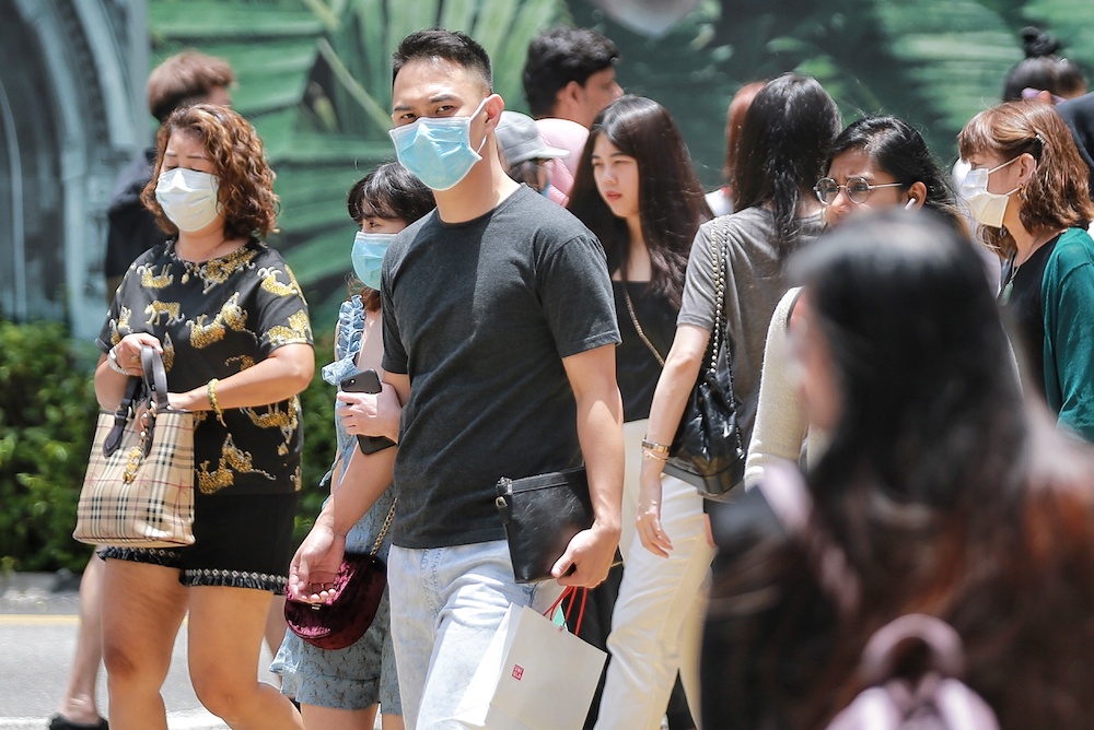 Members of the public are seen going about wearing face masks in Kuala Lumpur, March 14, 2020. u00e2u20acu201d Picture by Ahmad Zamzahuri