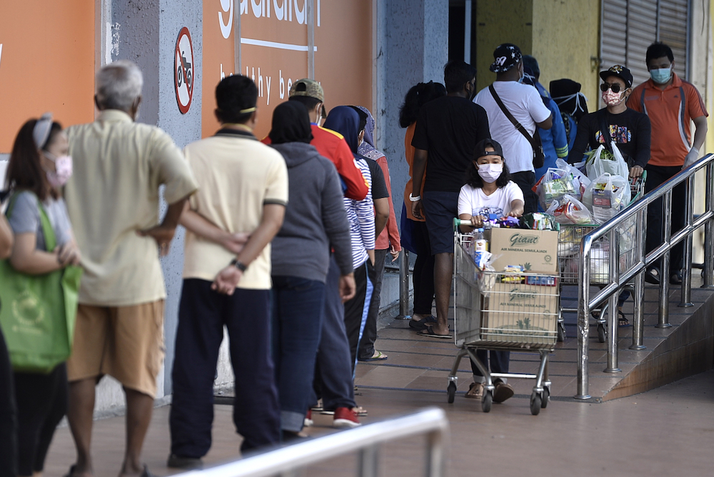 People keeping their distance from each other outside Giant Hypermarket during the movement control order (MCO) in Shah Alam April 5, 2020. u00e2u20acu201d Picture by Miera Zulyana
