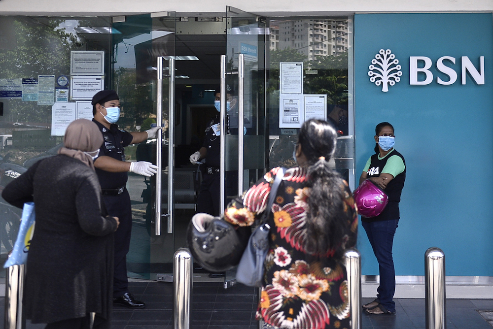 People queue in front of a Bank Simpanan Nasional branch in Kuala Lumpur April 6, 2020. u00e2u20acu201d Picture by Miera Zulyana