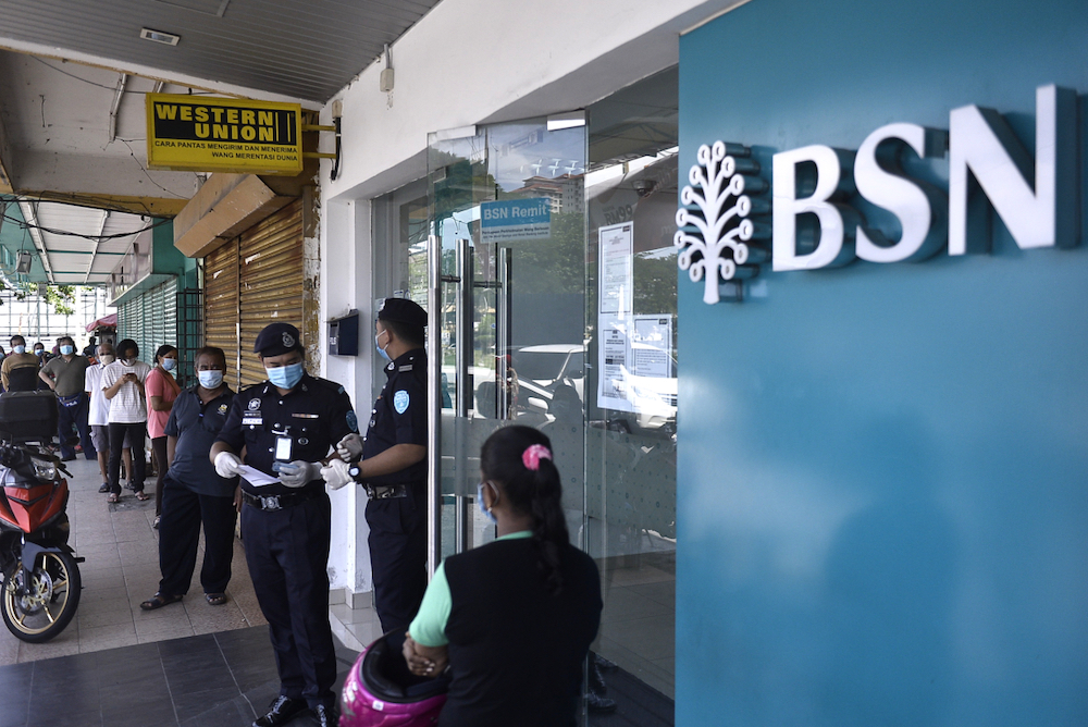 People queue in front of a Bank Simpanan Nasional branch in Kuala Lumpur April 6, 2020. u00e2u20acu201d Picture by Miera Zulyana