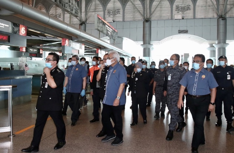 Home Minister Datuk Seri Hamzah Zainudin (centre) during his visit to the Bangunan Sultan Iskandar building that houses the customs, immigration and quarantine (CIQ) facility in Johor Baru, April 7, 2020. u00e2u20acu201d Picture by Ben Tan