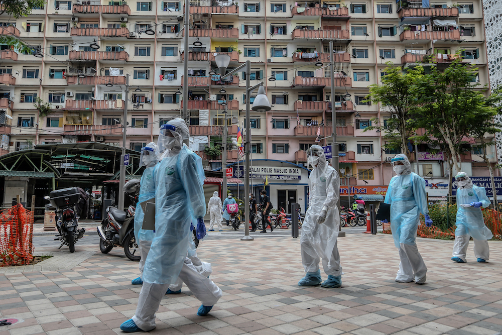 Health workers in protective suits are seen at Selangor Mansion and Malayan Mansion in Jalan Masjid India April 7, 2020. u00e2u20acu201d Picture by Firdaus Latif