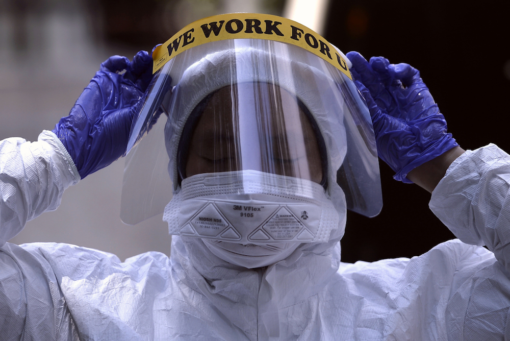 A health worker in protective suits is seen after conducting Covid-19 testing at Lorong Jalan Puyuh, Shah Alam April 12, 2020. u00e2u20acu201d Picture by Miera Zulyana