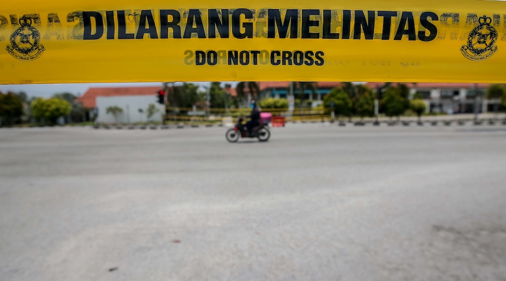 As the country continues to battle the Covid-19 pandemic, police are closing more roads to ensure the people adhere to the movement control order. In Ipoh, the entrance to Kampung Sungai Rokam is closed to traffic. u00e2u20acu201d Picture by Farhan Najib