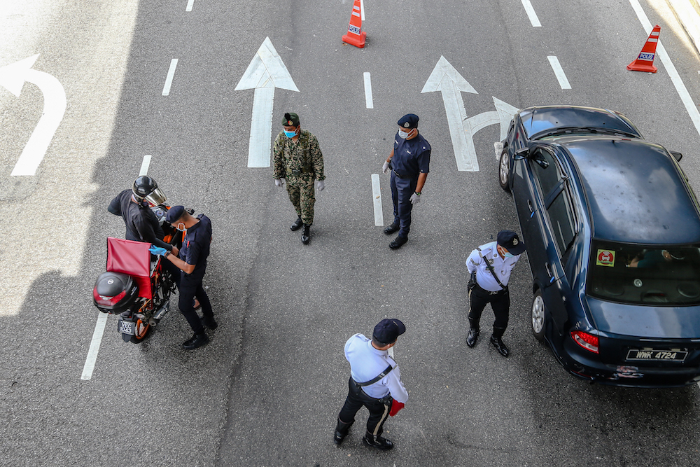 Police and Armed Forces personnel conduct checks on vehicles during a roadblock on Jalan Pahang in Kuala Lumpur April 15, 2020. u00e2u20acu201d Picture by Firdaus Latif
