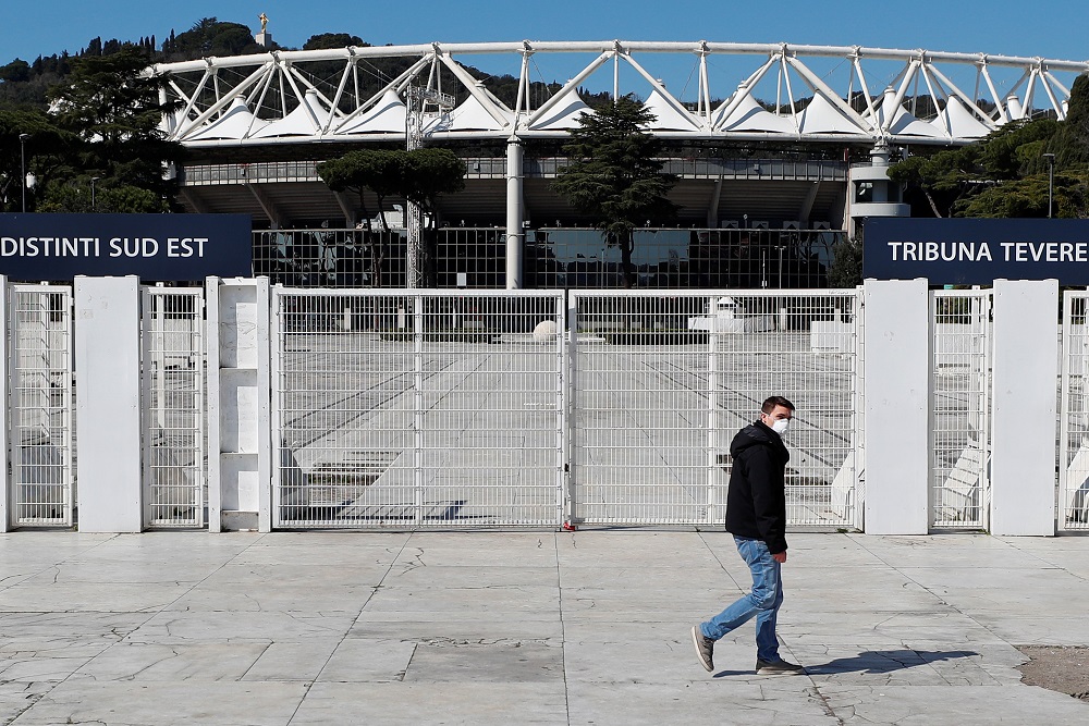 A man wearing a protective face mask walks past Rome's Olympic Stadium, one of the venues planned for the Euro 2020 tournament, which is under growing pressure to be postponed due to coronavirus, in Rome March 16, 2020. u00e2u20acu201d Reuters pic