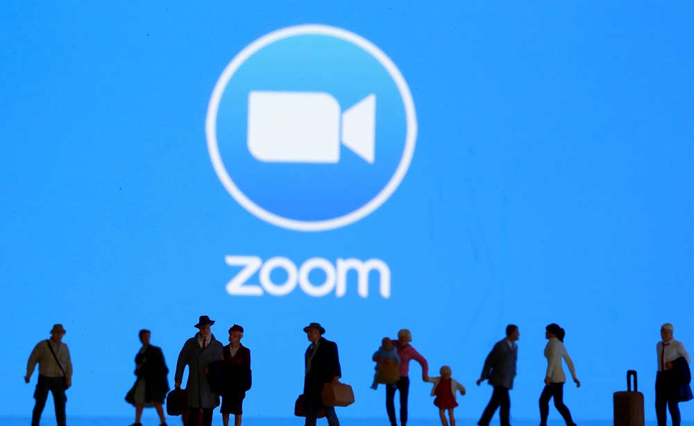 Small toy figures are seen in front of diplayed Zoom logo in this illustration taken March 19, 2020. u00e2u20acu201d Reuters pic