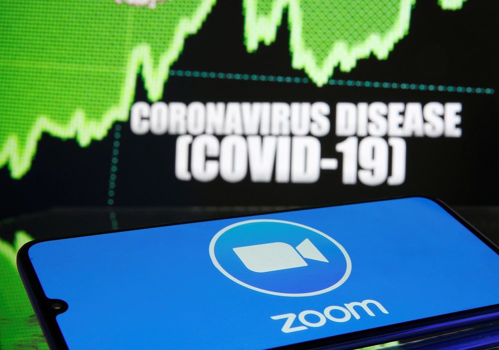 Zoom logo is seen in front of displayed coronavirus disease in this illustration taken March 19, 2020. u00e2u20acu201d Reuters pic