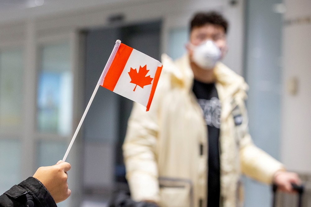 A traveller wears a mask at Pearson airport arrivals, shortly after Toronto Public Health received notification of Canadau00e2u20acu2122s first presumptive confirmed case of novel coronavirus, in Toronto January 26, 2020. u00e2u20acu201d Reuters pic