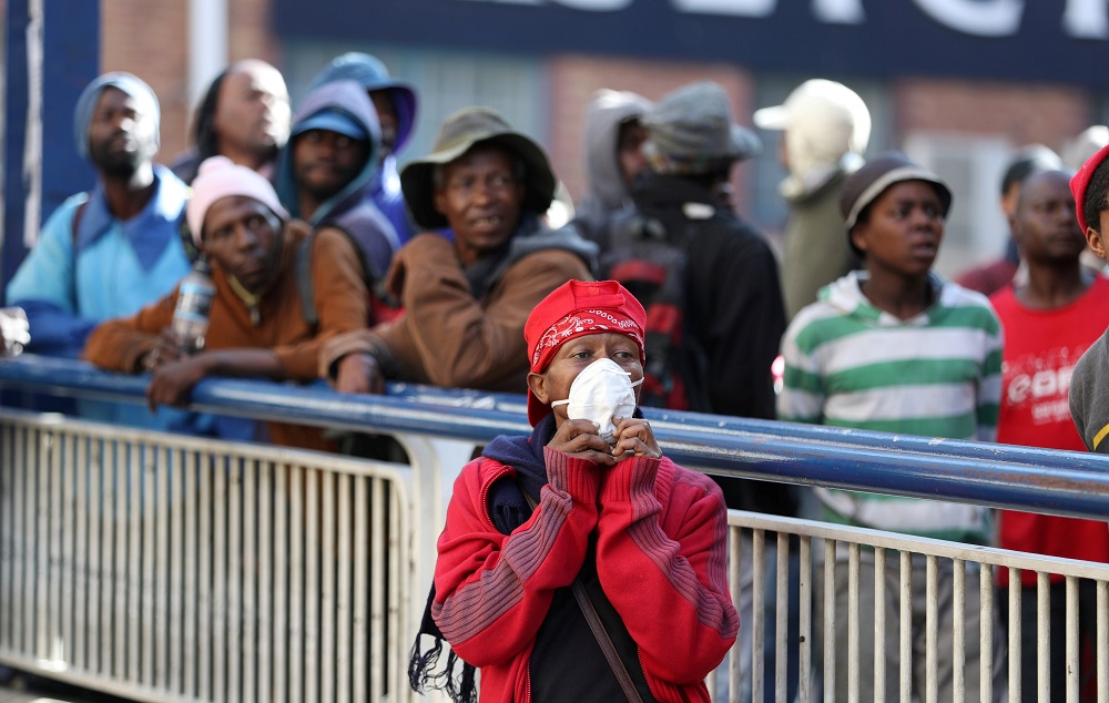 Homeless people look on as members of the South African National Defence Force patrol the streets of Johannesburg March 27, 2020. u00e2u20acu201d Reuters pic