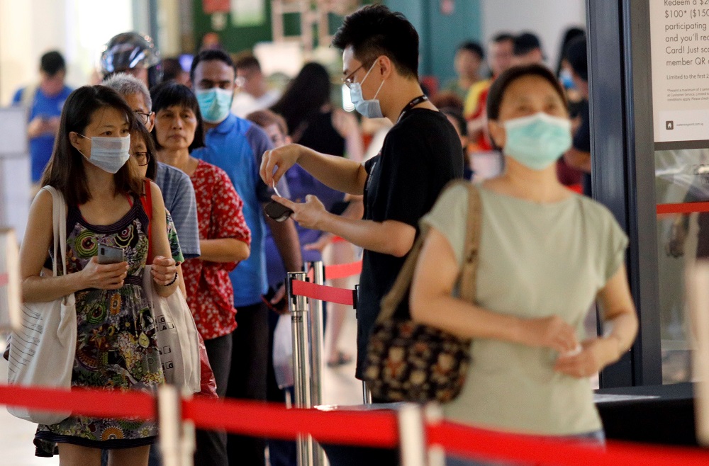 People queue to enter a mall, as mall capacity is regulated in a series of social distancing measures to curb the outbreak of coronavirus disease in Singapore March 27, 2020. u00e2u20acu201d Reuters pic