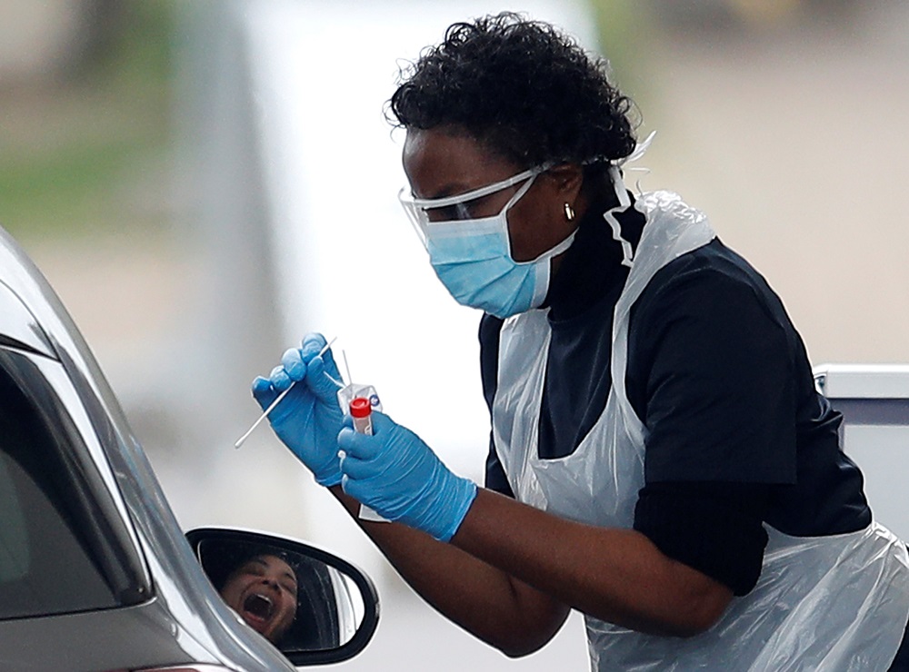 Medical staff at an NHS drive through coronavirus disease (Covid-19) testing facility in the car park of Chessington World of Adventures, as the spread of the coronavirus disease continues in Chessington March 30, 2020. u00e2u20acu201d Reuters pic