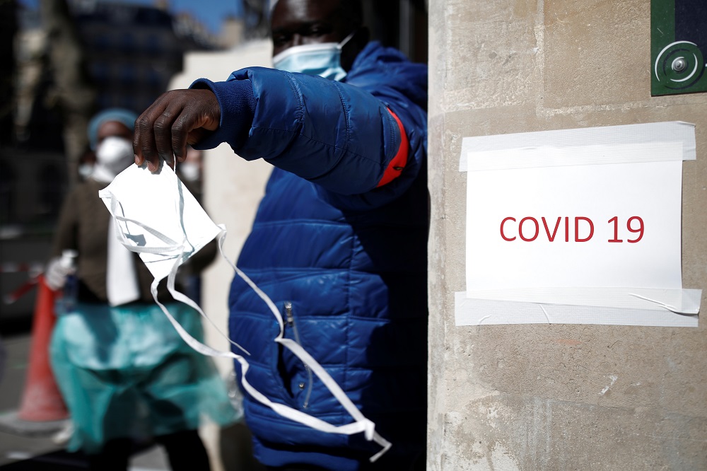 An employee holds a mask to a patient who arrives at a testing site for coronavirus disease in a medical centre in Paris as the spread of the coronavirus disease continues in France March 30, 2020. u00e2u20acu201d Reuters pic