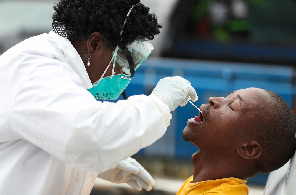 A member of medical staff swabs the mouth of a resident as she is testing him for a virus, during a nationwide lockdown for 21 days to try to contain the coronavirus disease outbreak, in Alexandra, South Africa March 31, 2020. u00e2u20acu201d Reuters pic