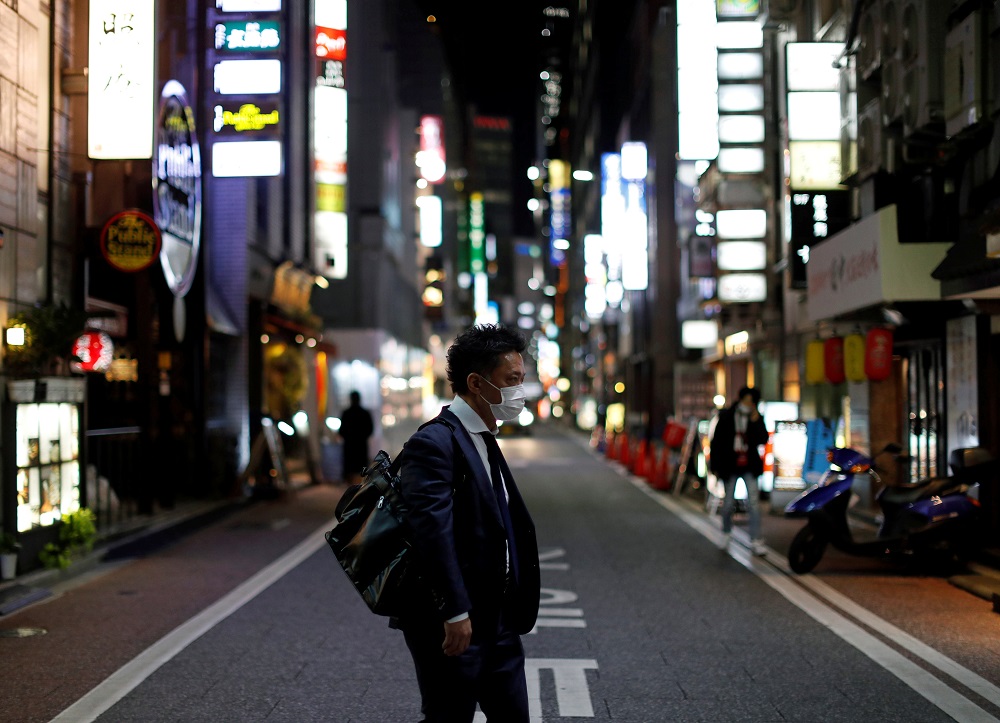 A man wearing a protective face mask, following an outbreak of the coronavirus disease (COVID-19), walks at Ginza shopping and amusement district in Tokyo April 2, 2020. u00e2u20acu201d Reuters pic