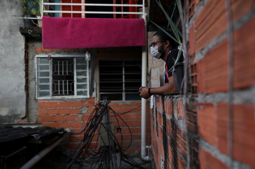 Marcus Vinicius Conceicao dos Santos, 22, looks out from his home as he self-isolates with another 19 people after showing symptoms of coronavirus disease, in the cityu00e2u20acu2122s biggest slum Paraisopolis, in Sao Paulo March 30, 2020. u00e2u20acu201d Reuters pic