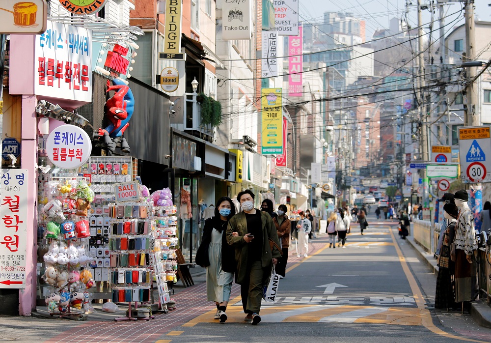 A couple wearing masks to protect against contracting the coronavirus disease (COVID-19) walk along a street in Seoul April 3, 2020. u00e2u20acu201d Reuters pic