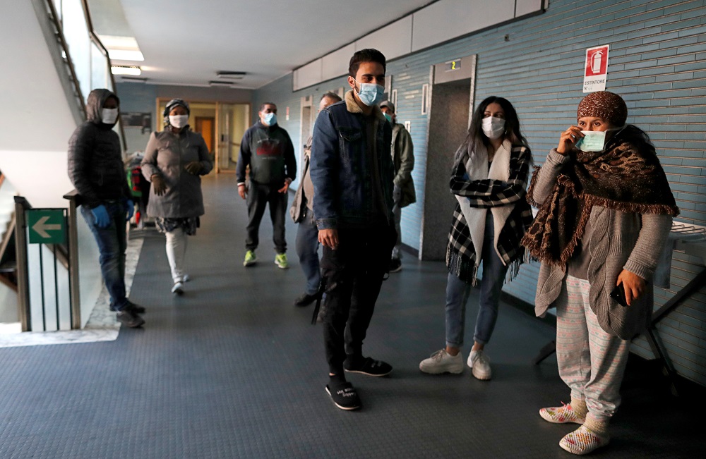 People wait to be checked by the medical team of NGO Intersos in a squatted building as the spread of coronavirus disease (COVID-19) continues, in Rome April 3, 2020. u00e2u20acu201d Reuters pic