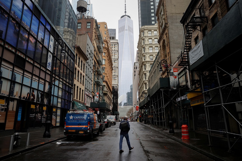A man crosses a nearly deserted Fulton Street in the financial district in lower Manhattan during the outbreak of the coronavirus disease in New York April 3, 2020.  u00e2u20acu201d Reuters pic 