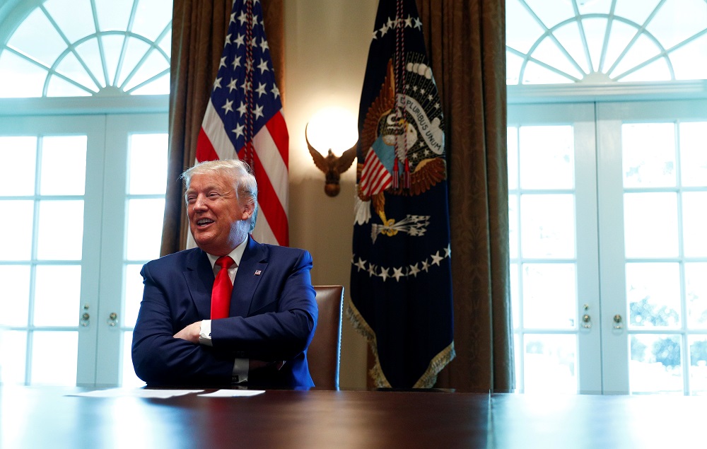 US President Donald Trump laughs during a roundtable meeting with energy sector CEOs in the Cabinet Room of the White House in Washington April 3, 2020. — Reuters pic