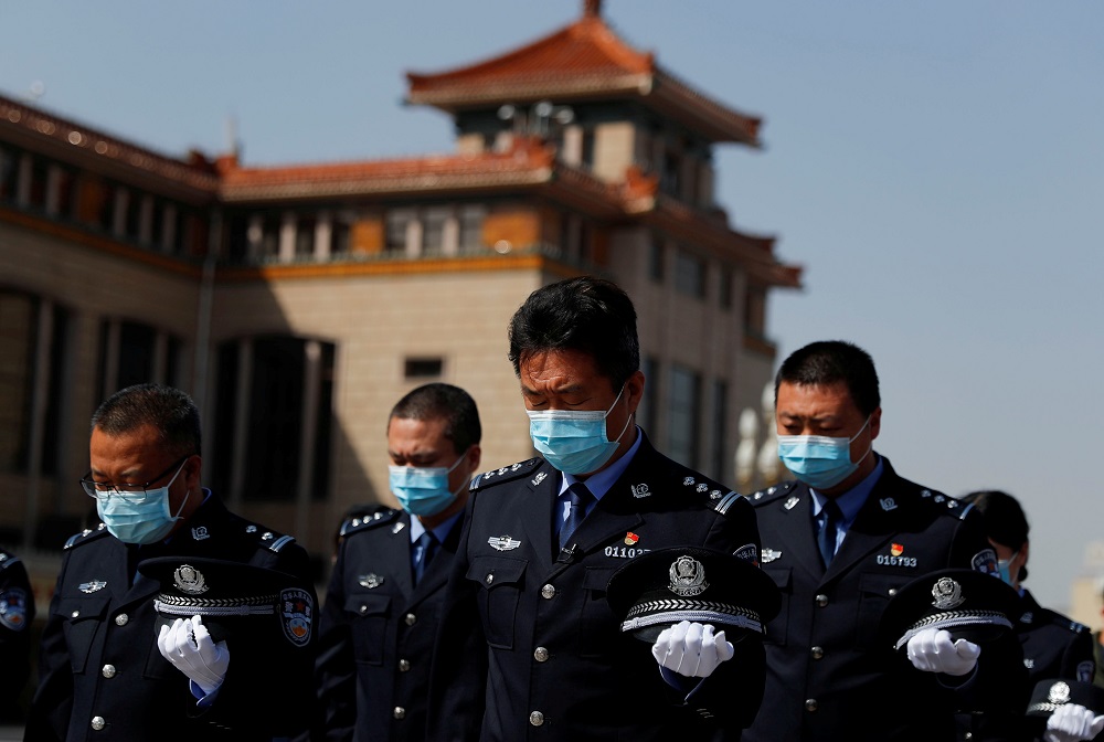Security personnel wearing face masks stand to pay tribute as China holds national mourning for those who died of the coronavirus disease, on the Qingming tomb-sweeping festival in Beijing April 4, 2020. u00e2u20acu201d Reuters pic
