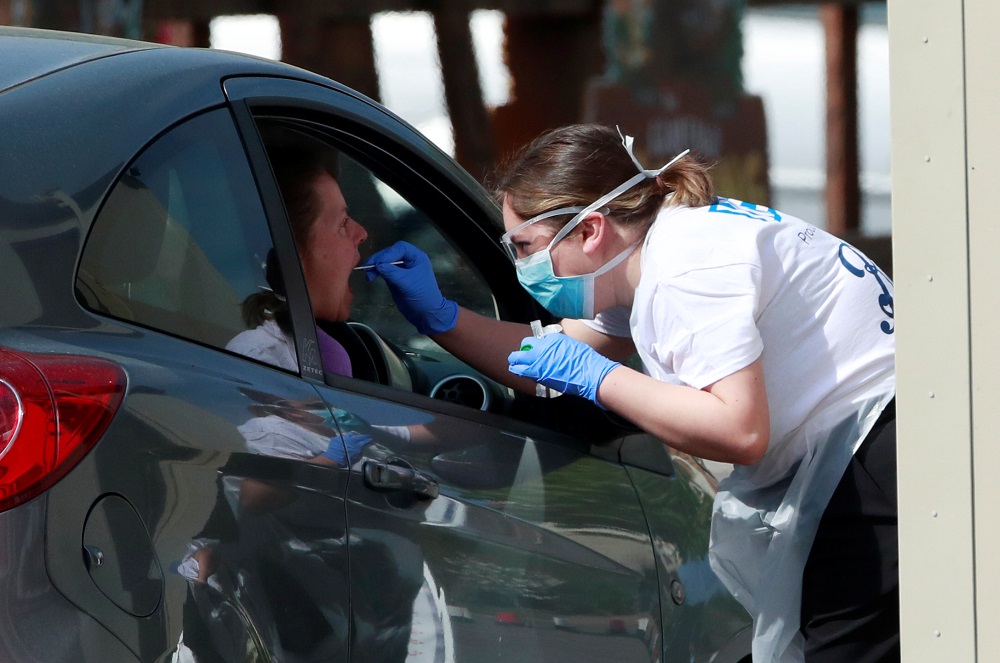 A woman is tested at a coronavirus test centre in the car park of Chessington World of Adventures as the spread of the coronavirus disease continues, in Chessington April 15, 2020. u00e2u20acu201d Reuters pic