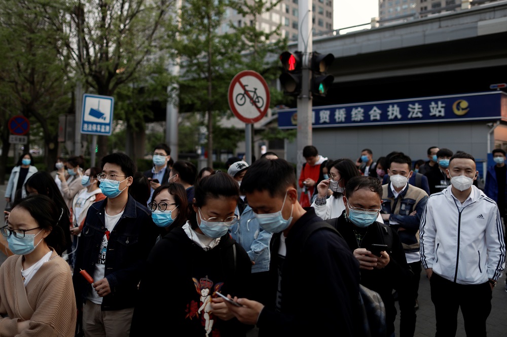 People wearing protective face masks leave work after office hours in Central Business District, as the spread of the new coronavirus disease continues, in Beijing April 17, 2020. u00e2u20acu201d Reuters pic