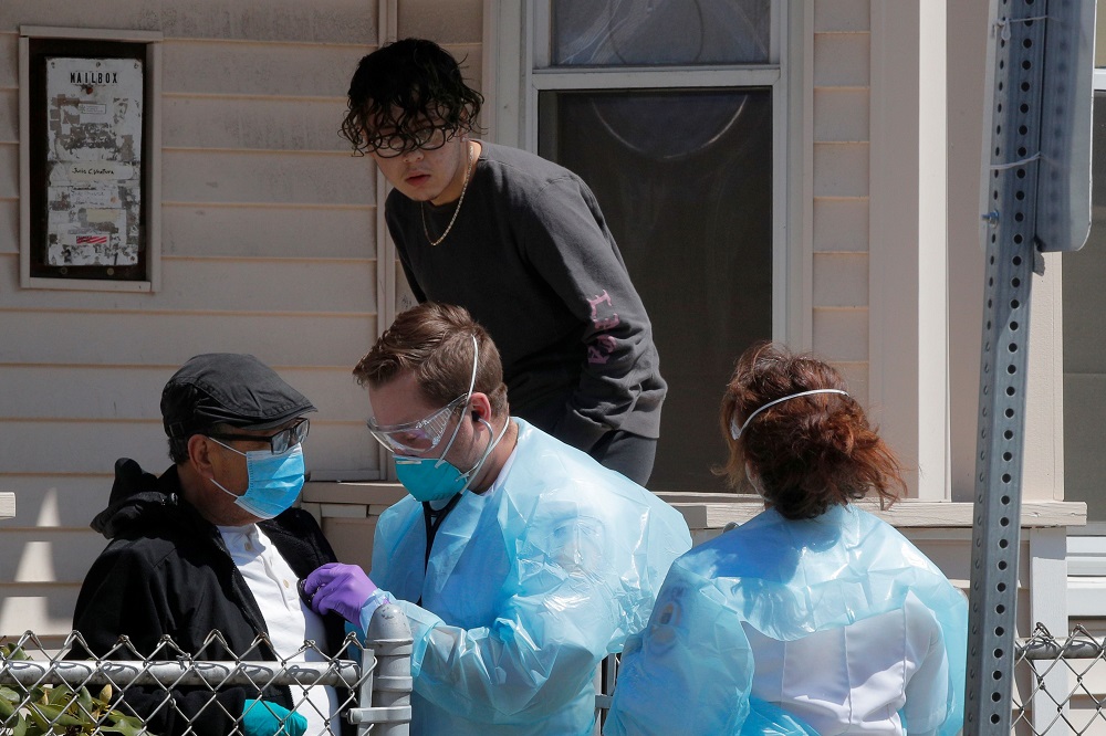 Medics check on a patient who declined to go to the hospital amid the coronavirus disease outbreak in Chelsea, Massachusetts April 17, 2020. u00e2u20acu201d Reuters pic