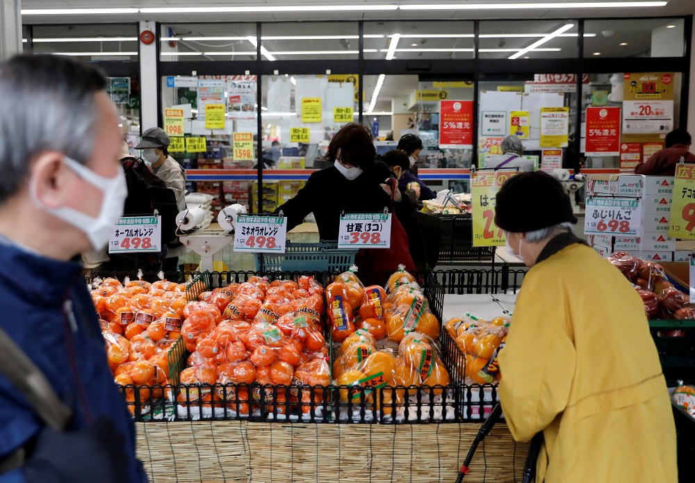 Shoppers wearing protective face masks, following an outbreak of the coronavirus disease, are seen at a supermarket in Tokyo March 27, 2020. u00e2u20acu201d Reuters pic