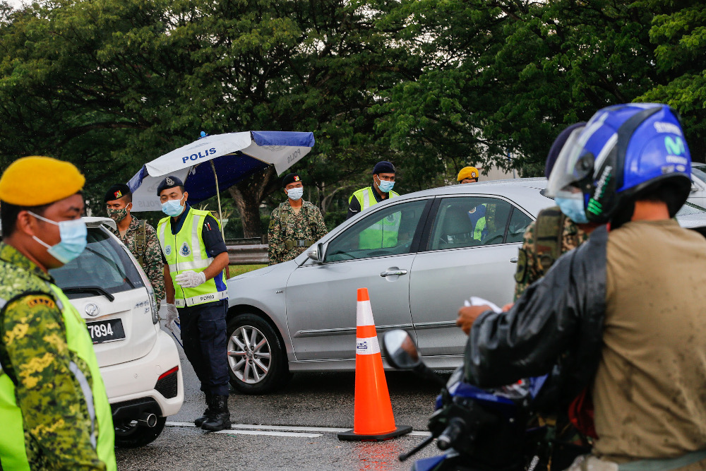 Policemen along with Army and RELA personnel join forces to man roadblocks near the Penang Bridge Toll Plaza April 3, 2020. u00e2u20acu201d Picture by Sayuti Zainudin