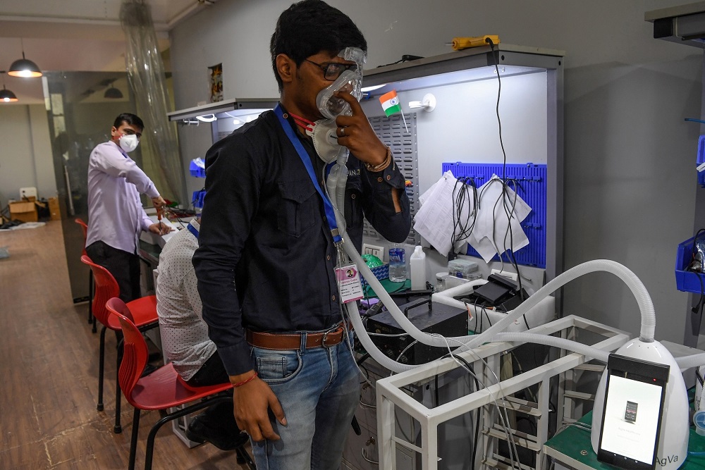 AgVa Healthcare employee Vaibhav Gupta demonstrates using a ventilator at the research and development (R&D) centre in Noida in Uttar Pradesh state. u00e2u20acu201d AFP pic