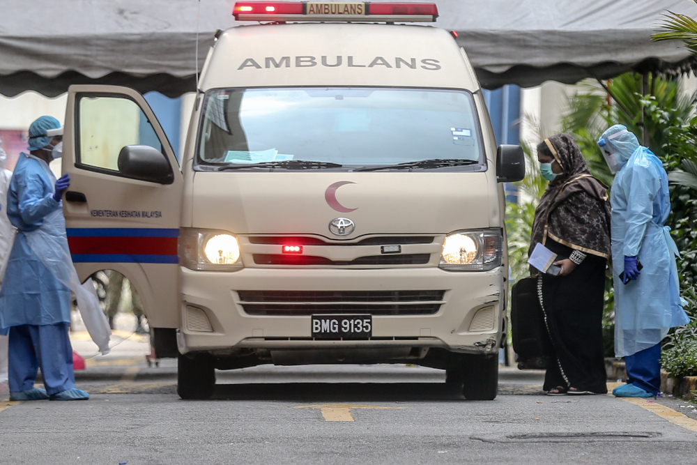 Health workers evacuate suspected Covid-19 victims from Menara City One during the enhanced movement control order (EMCO) in Kuala Lumpur April 5, 2020. u00e2u20acu201d Picture by Firdaus Latif