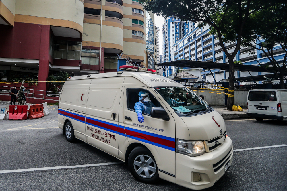 An ambulance leaves Menara City One during the enhanced movement control order (EMCO) in Kuala Lumpur April 5, 2020. u00e2u20acu201d Picture by Firdaus Latif