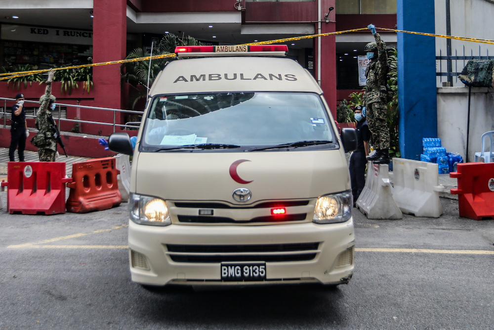 An ambulance leaves Menara City One during the enhanced movement control order (EMCO) in Kuala Lumpur April 5, 2020. u00e2u20acu201d Picture by Firdaus Latif