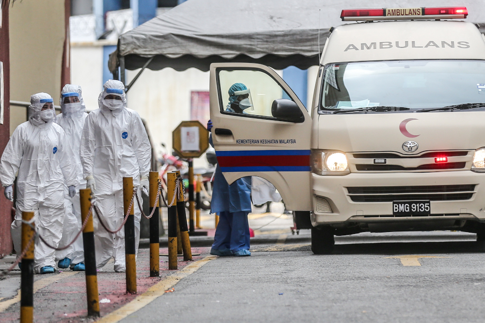 Health workers evacuate suspected Covid-19 victims from Menara City One during the enhanced movement control order (EMCO) in Kuala Lumpur April 5, 2020. u00e2u20acu201d Picture by Firdaus Latif