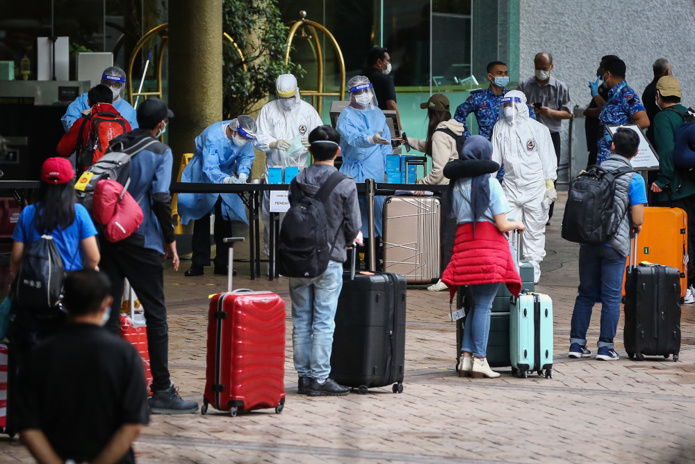 Malaysians returning from overseas queue to take a bus to a quarantine centre in Kuala Lumpur April 8, 2020. u00e2u20acu201dPicture by Yusof Mat Isa