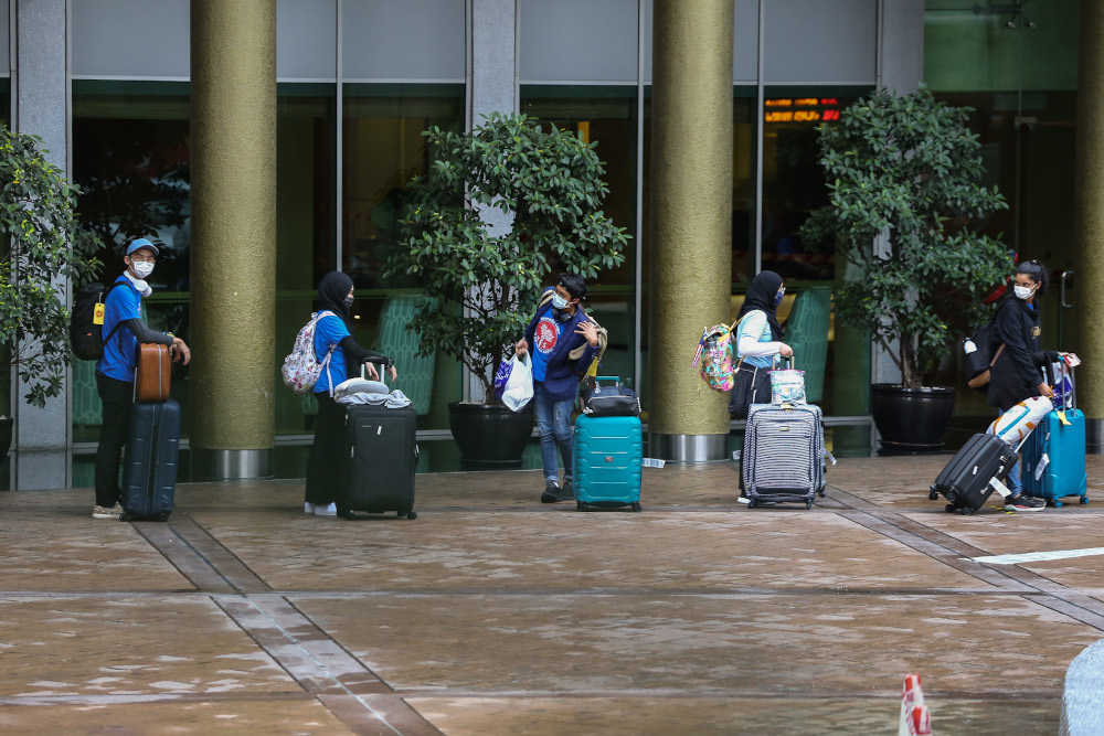 Malaysians returning from overseas queue to take a bus to a quarantine centre in Kuala Lumpur April 8, 2020. u00e2u20acu201dPicture by Yusof Mat Isa