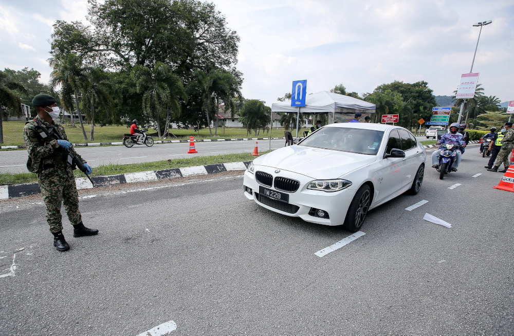 Police and armed forces personnel join forces at the roadblocks to implement the movement control order at Jalan Tambun Ipoh April 10, 2020. u00e2u20acu201d Picture by Farhan Najib