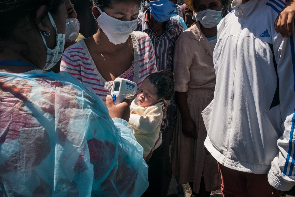 A worker from the Ministry of Health measures a baby's temperature at the Maki bus station to take take buses to Madagascar's main cities, in Antananarivo, on April 7, 2020. u00e2u20acu201d AFP picn n