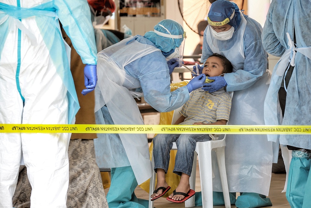 Health workers test a child for Covid-19 in Kampung Baru, Kuala Lumpur April 17, 2020. u00e2u20acu201d Picture by Ahmad Zamzahuri