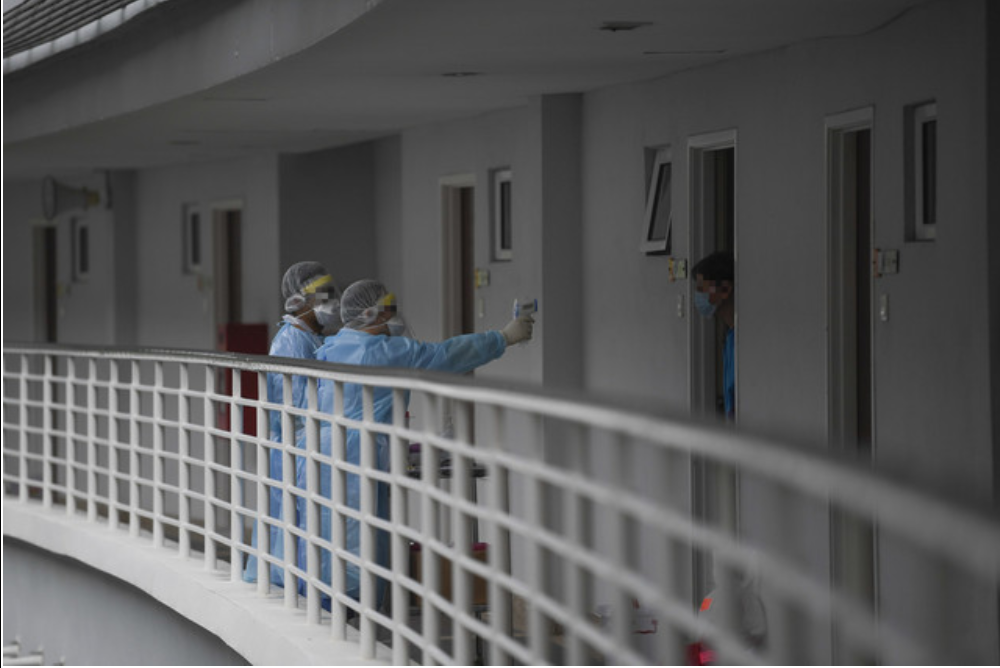 Health workers check the body temperature of an individual under quarantine at the Higher Education Leadership Academy (AKEPT) in Bandar Enstek in Nilai February 18, 2020. u00e2u20acu201d Bernama pic