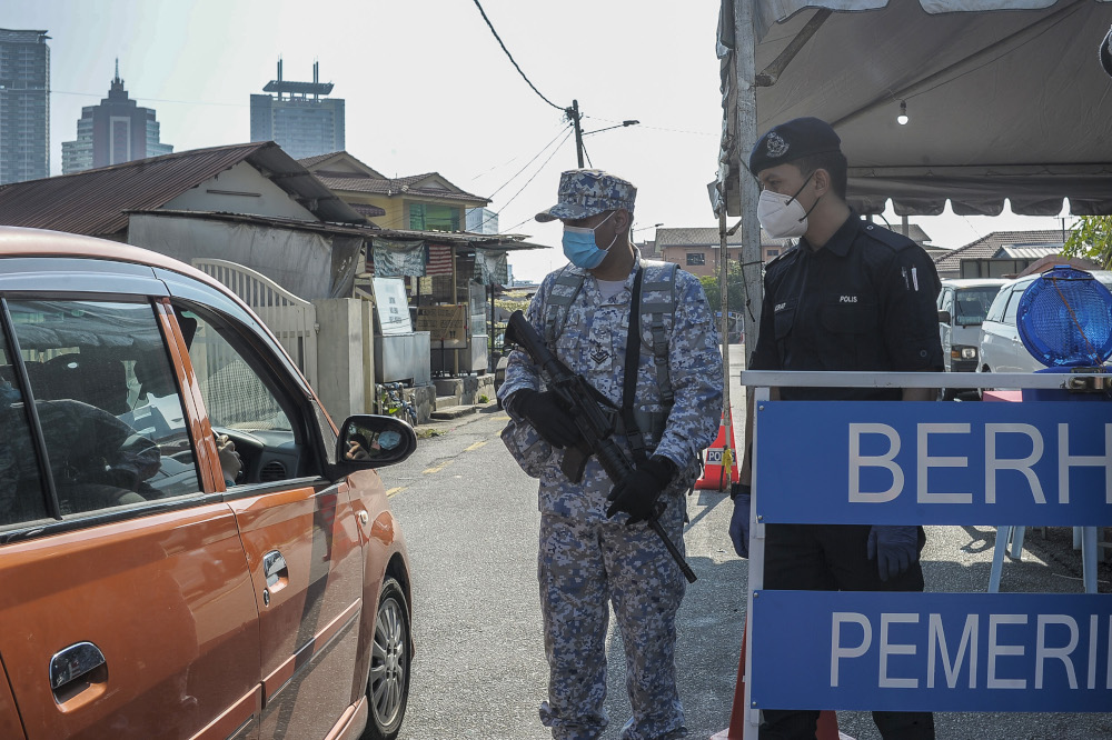 Army and police personnel conducting roadblocks during the movement control order (MCO) in Kuala Lumpur April 19, 2020. u00e2u20acu201d Picture by Shafwan Zaidon